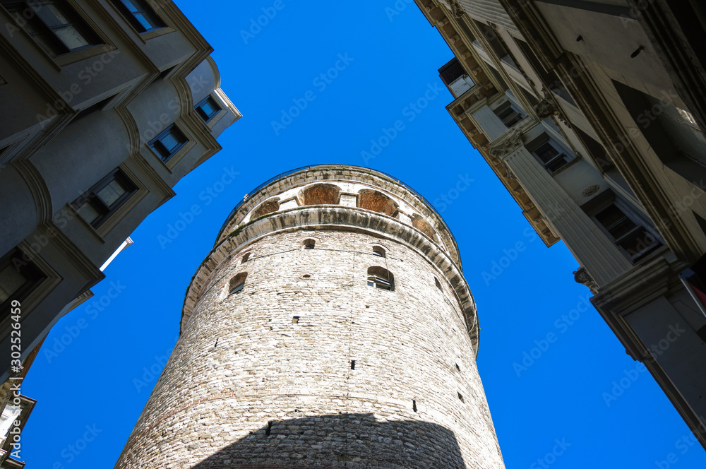 Bottom view of Galata tower against blue sky, Istanbul.