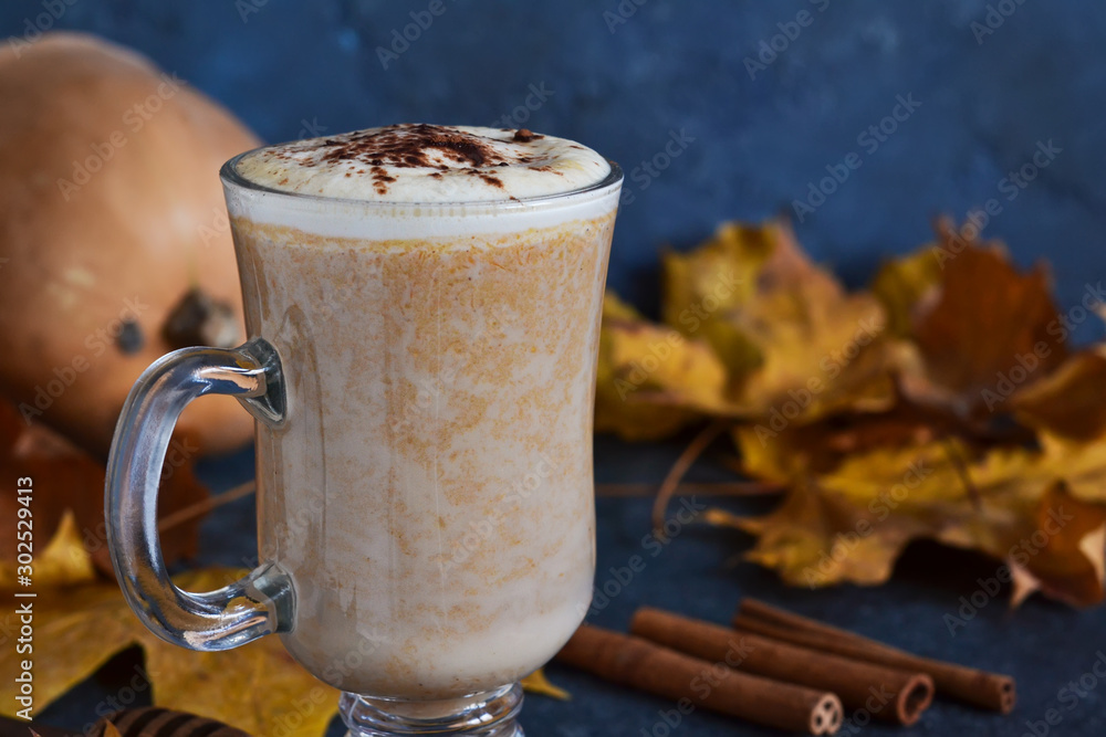 Latte with pumpkin and cinnamon on a concrete background. Latte with pumpkin and cinnamon on a concrete background.