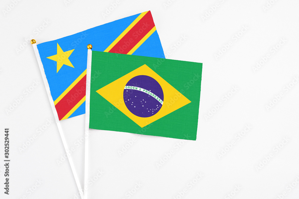 Brazil and Congo stick flags on white background. High quality fabric, miniature national flag. Peaceful global concept.White floor for copy space.
