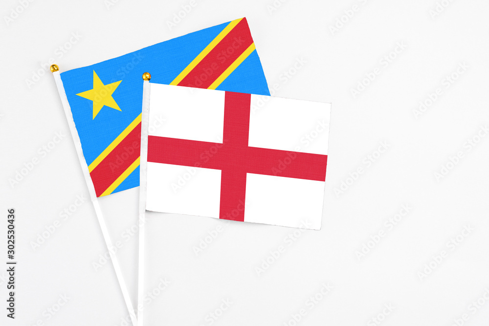 England and Congo stick flags on white background. High quality fabric, miniature national flag. Peaceful global concept.White floor for copy space.