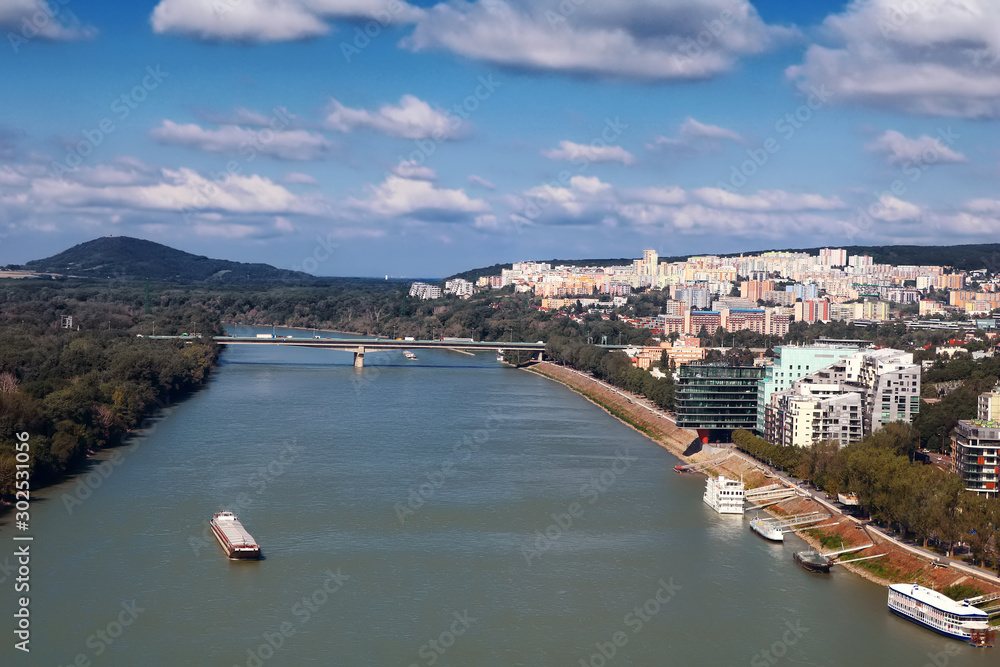 View of ship on the Danube River, the Lafranconi bridge and new buildings in a residential area in Bratislava, Slovakia