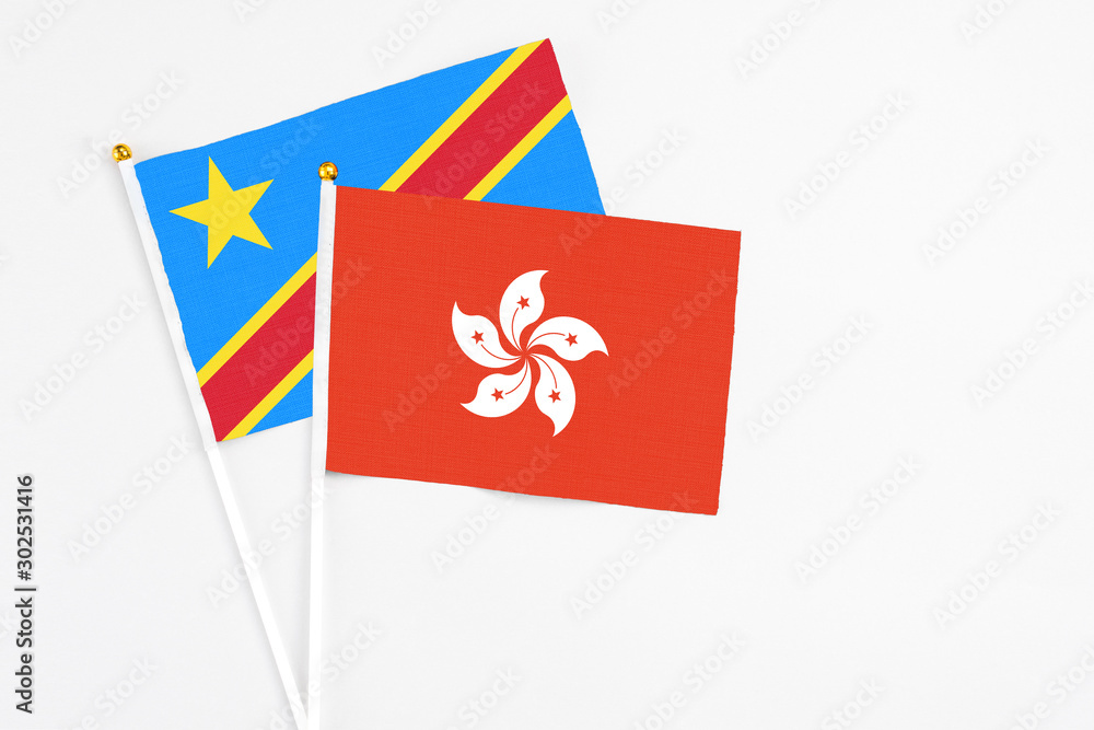 Hong Kong and Congo stick flags on white background. High quality fabric, miniature national flag. Peaceful global concept.White floor for copy space. Hong Kong and Congo stick flags on white background. High quality fabric, miniature national flag. Peaceful global concept.White floor for copy space.