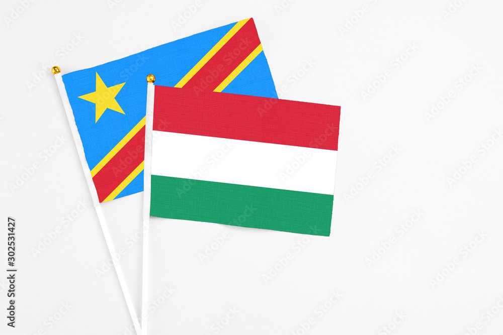 Hungary and Congo stick flags on white background. High quality fabric, miniature national flag. Peaceful global concept.White floor for copy space. Hungary and Congo stick flags on white background. High quality fabric, miniature national flag. Peaceful global concept.White floor for copy space.