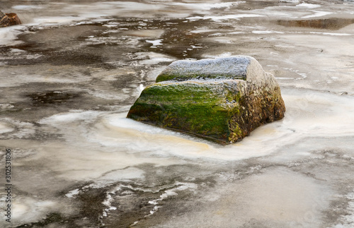 Rock in frozen river