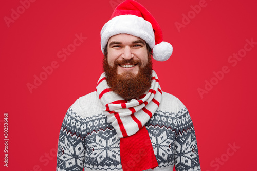 Happy male in Santa hat and striped scarf