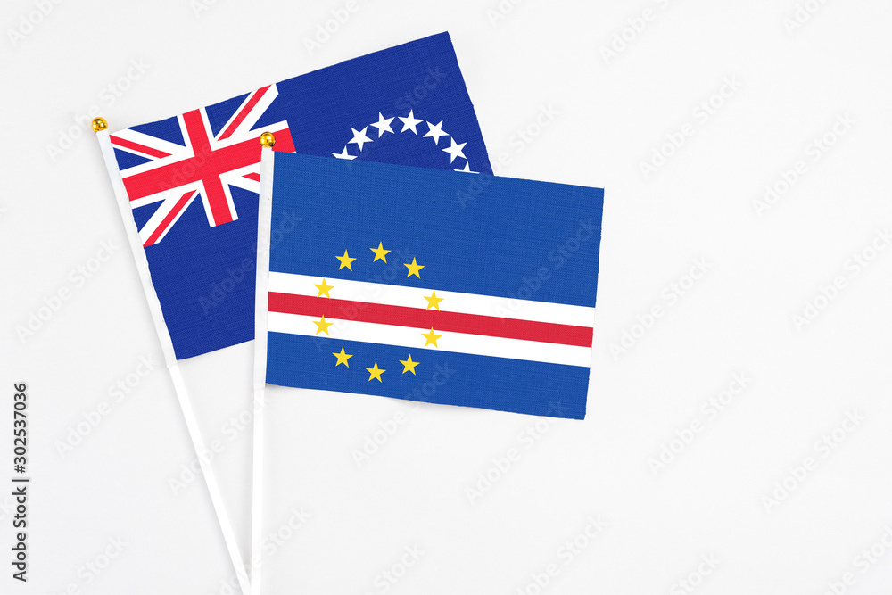Cape Verde and Cook Islands stick flags on white background. High quality fabric, miniature national flag. Peaceful global concept.White floor for copy space. Cape Verde and Cook Islands stick flags on white background. High quality fabric, miniature national flag. Peaceful global concept.White floor for copy space.
