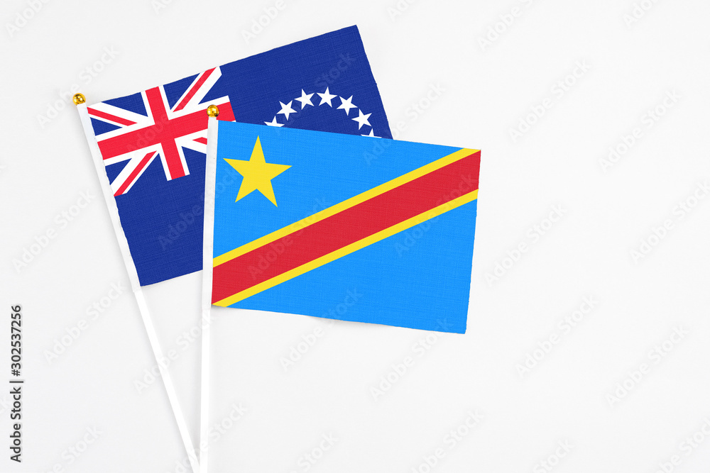 Congo and Cook Islands stick flags on white background. High quality fabric, miniature national flag. Peaceful global concept.White floor for copy space. Congo and Cook Islands stick flags on white background. High quality fabric, miniature national flag. Peaceful global concept.White floor for copy space.