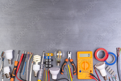 Electrician equipment on metalic background, top view	