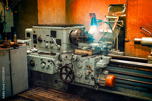 Obsolete metal lathe in an old machine shop