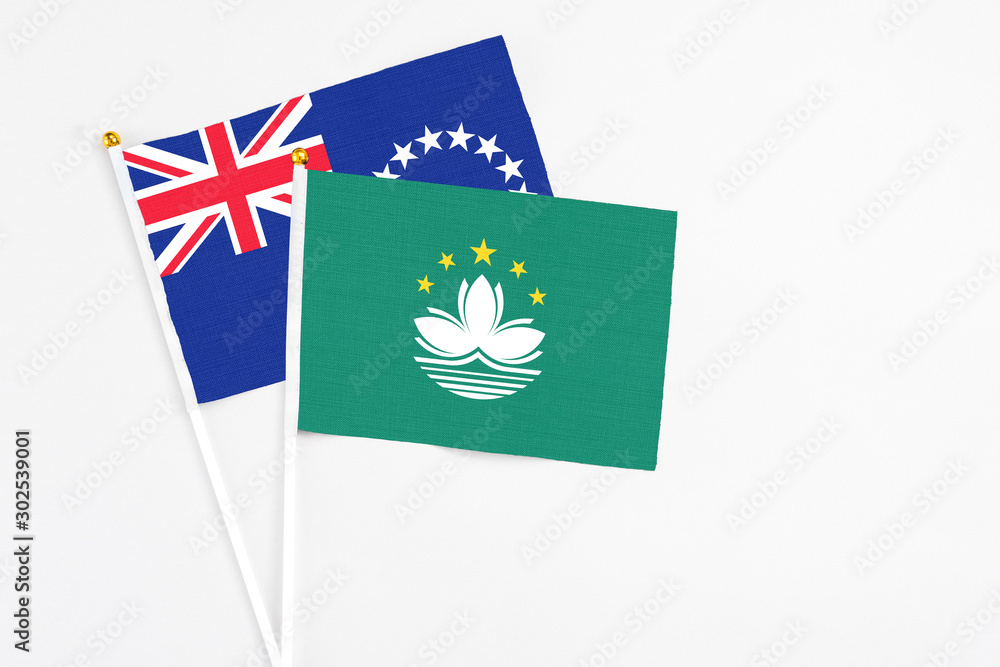 Macao and Cook Islands stick flags on white background. High quality fabric, miniature national flag. Peaceful global concept.White floor for copy space. Macao and Cook Islands stick flags on white background. High quality fabric, miniature national flag. Peaceful global concept.White floor for copy space.