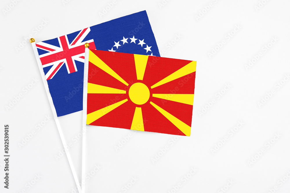 Macedonia and Cook Islands stick flags on white background. High quality fabric, miniature national flag. Peaceful global concept.White floor for copy space. Macedonia and Cook Islands stick flags on white background. High quality fabric, miniature national flag. Peaceful global concept.White floor for copy space.
