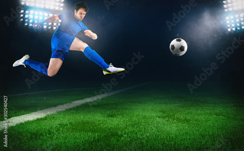 Football scene at night match with a soccer player running to kick the ball at the stadium