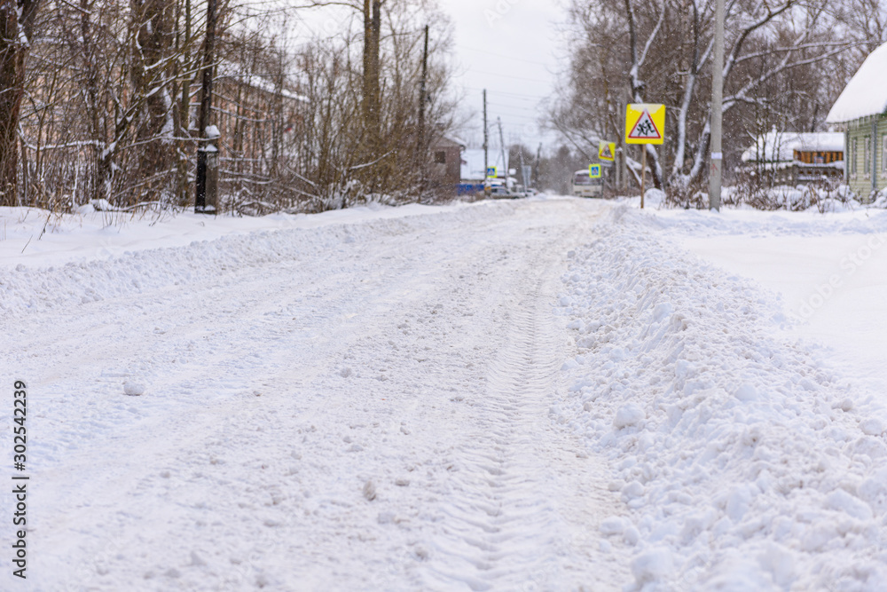 Winter, snowy road. Traces of a car in the snow. Snowdrifts of snow. Winter, snowy road. Traces of a car in the snow. Snowdrifts of snow.