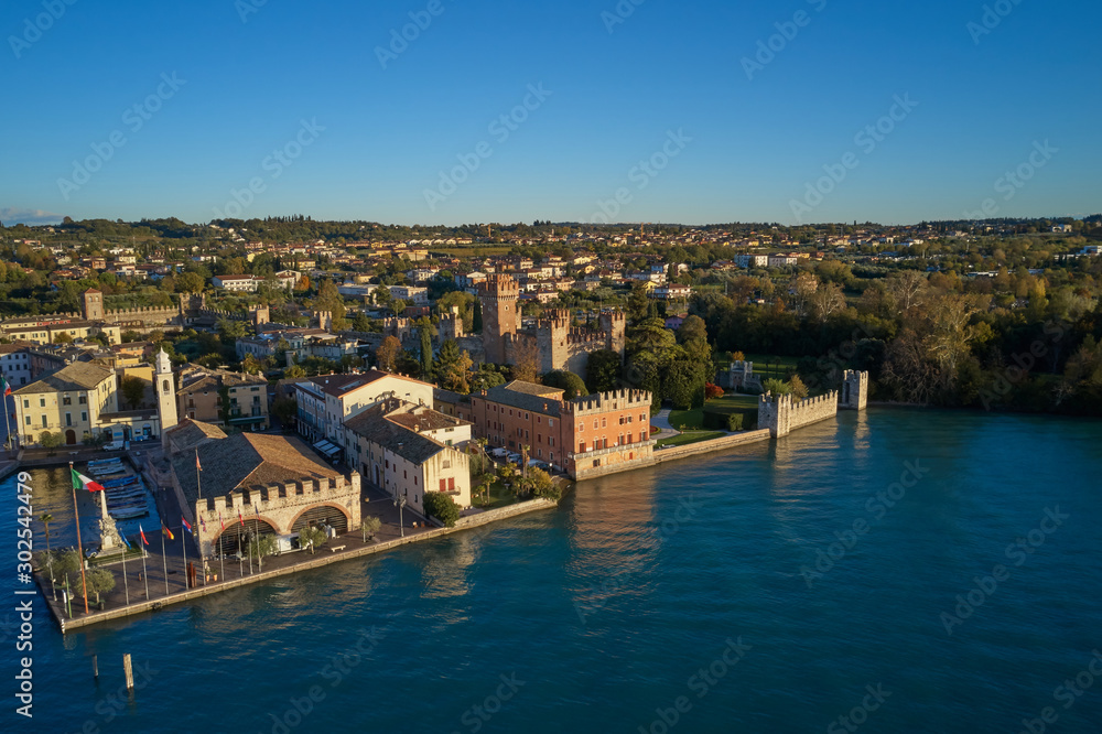 Aerial view of Lake Garda and the city center of Lazise, Italy. Autumn season, blue sky