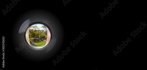 View through peephole in door looking out to entry photo