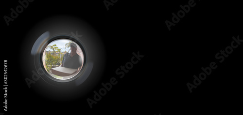 Quadro su tela Peephole View of parcel delivery man outside door to entry