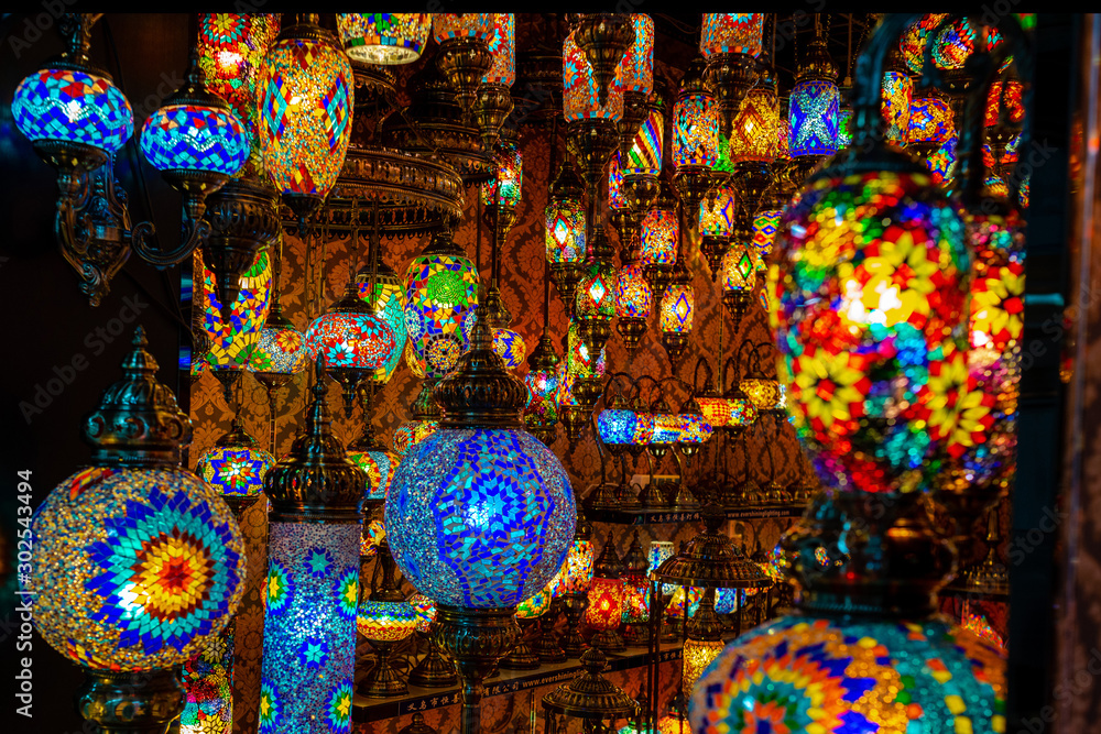 A lot of colorized lanterns in the room