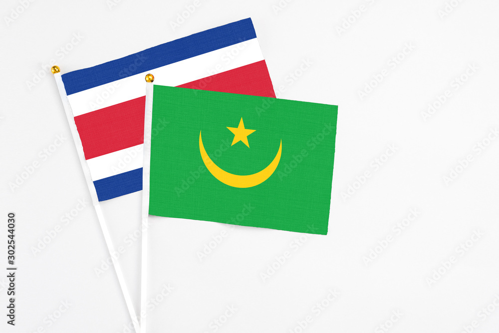 Mauritania and Costa Rica stick flags on white background. High quality fabric, miniature national flag. Peaceful global concept.White floor for copy space. Mauritania and Costa Rica stick flags on white background. High quality fabric, miniature national flag. Peaceful global concept.White floor for copy space.