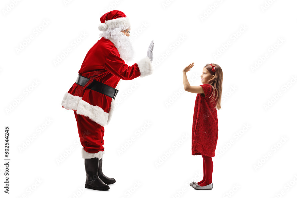 Santa Claus gesturing high-five with a little girl Santa Claus gesturing high-five with a little girl