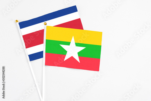 Myanmar and Costa Rica stick flags on white background. High quality fabric  miniature national flag. Peaceful global concept.White floor for copy space.
