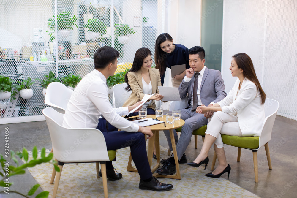 Chinese business people having a meeting in office Chinese business people having a meeting in office