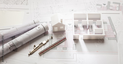 Construction concept. Residential building drawings and architectural model,