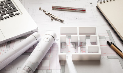 Construction concept. Residential building drawings and house model,