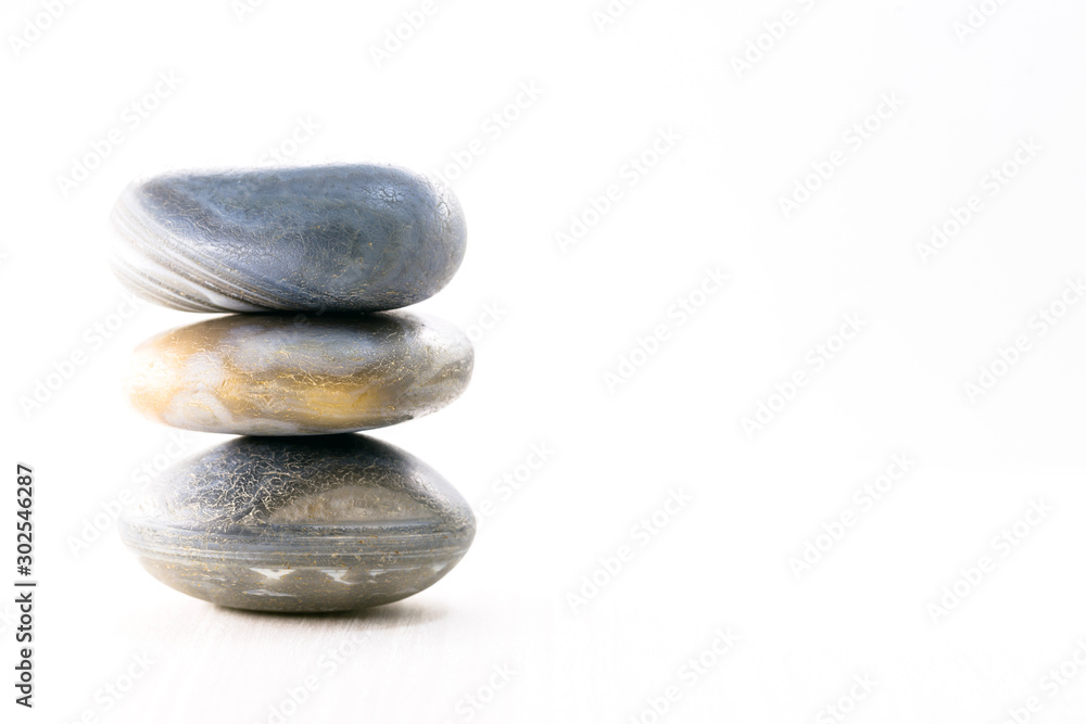 Pile of stones isolated on white background, Stones for massage and zen lifestyle. Mystic stones in balance. Pile of stones isolated on white background, Stones for massage and zen lifestyle. Mystic stones in balance.