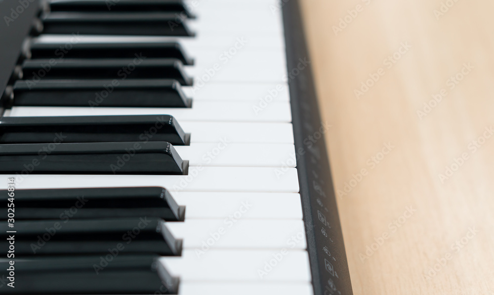 Closeup piano keys on the wooden table with selective focus, electronic midi synthesizer keyboard for creative home studio Closeup piano keys on the wooden table with selective focus, electronic midi synthesizer keyboard for creative home studio