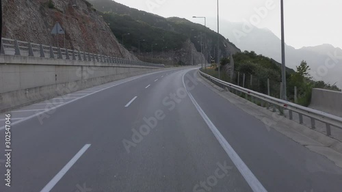 View from a car driving along a mountain road. Early morning. The route runs through the mountainous Greek regions of Epirus and Macedonia, crossing the mountain ranges of Pindos and Vermio. photo