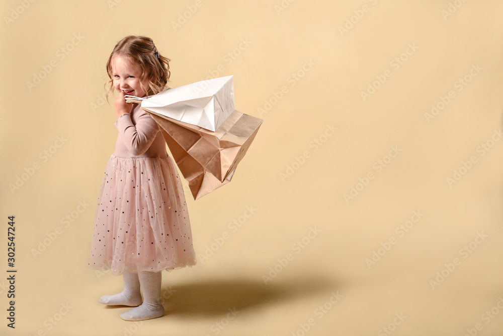 Small fashion girl . happy shopping girl runs with full bags and laughs. black Friday discount. cyber Monday. Present and gifts buy. summer sales. copy space. - obrazy, fototapety, plakaty 
