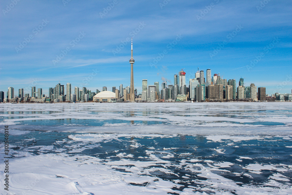 Toronto skyline with frozen lake, frozen lake and city, city skyline with frozen lake, frozen water, great lake frozen, beautiful sunny day with city buildings, sunny winter day, city skyline winter 