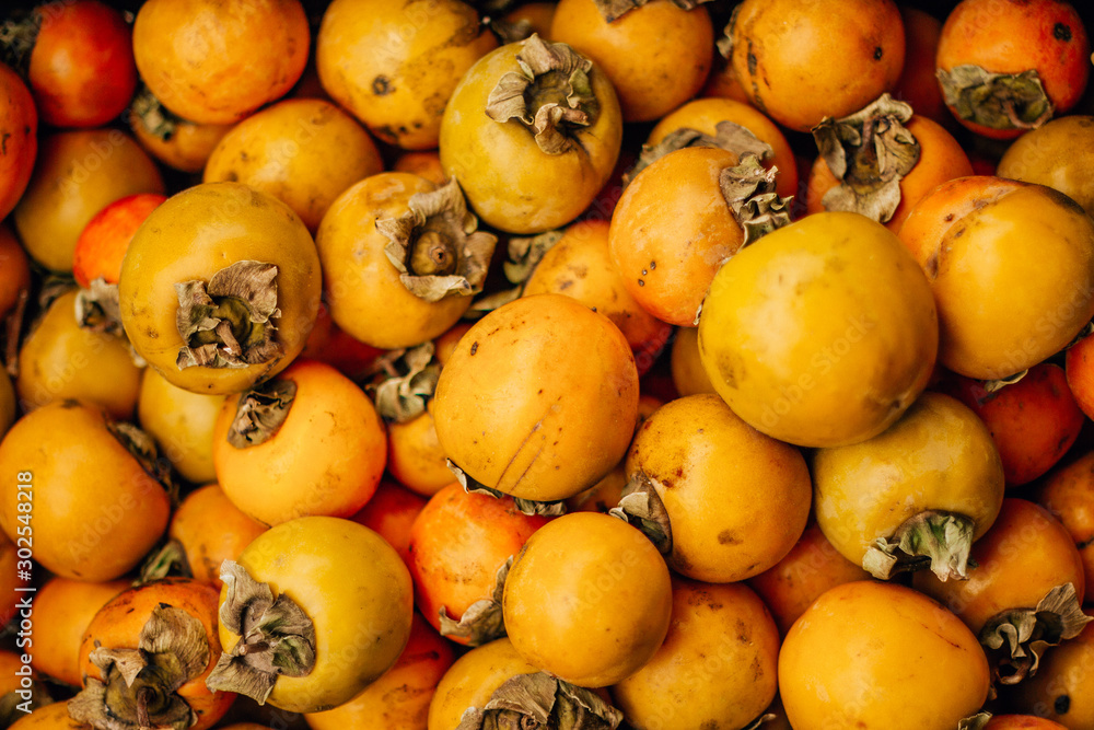  ripe tasty orange persimmon on the food market