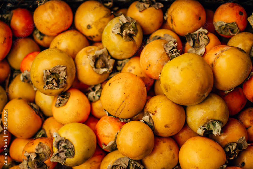  ripe tasty orange persimmon on the food market