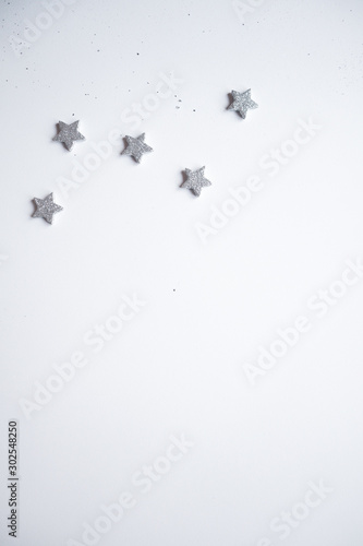 Christmas frame made Silver stars on white background. Winter concept. Flat lay, top view, copy space.Christmas composition.