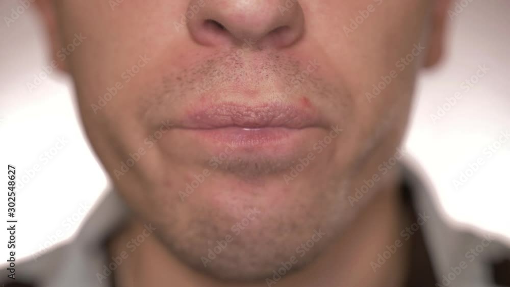 Close-up of a man eating a green pill, drinking water Close-up of a man eating a green pill, drinking water