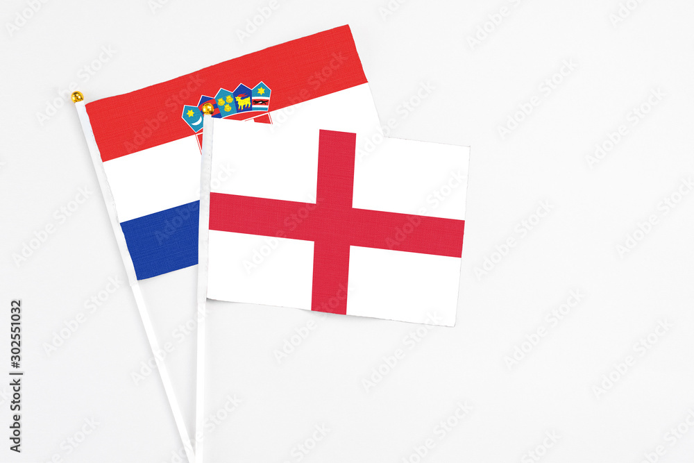 England and Croatia stick flags on white background. High quality fabric, miniature national flag. Peaceful global concept.White floor for copy space.