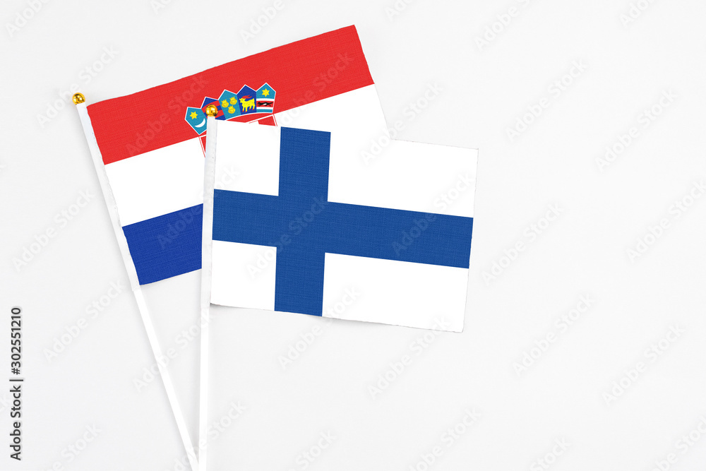 Finland and Croatia stick flags on white background. High quality fabric, miniature national flag. Peaceful global concept.White floor for copy space.