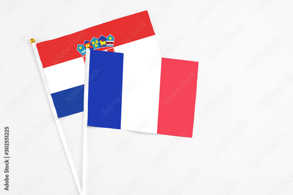 France and Croatia stick flags on white background. High quality fabric, miniature national flag. Peaceful global concept.White floor for copy space.