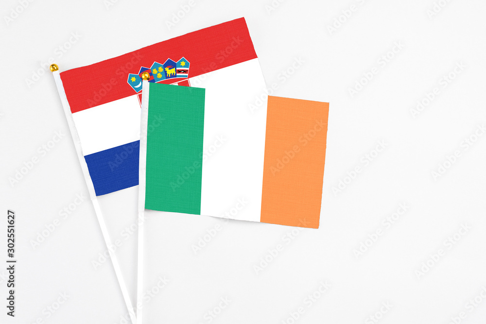 Ireland and Croatia stick flags on white background. High quality fabric, miniature national flag. Peaceful global concept.White floor for copy space. Ireland and Croatia stick flags on white background. High quality fabric, miniature national flag. Peaceful global concept.White floor for copy space.