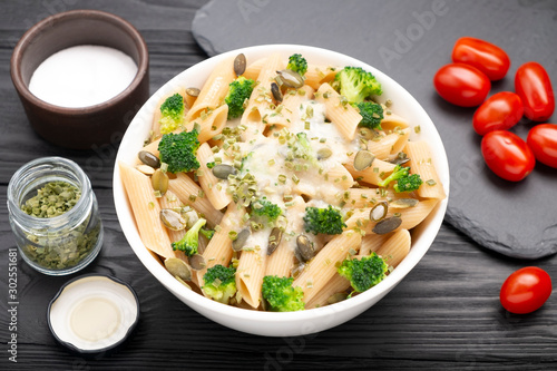 Pasta with white sauce, broccoli and pumpkin seeds