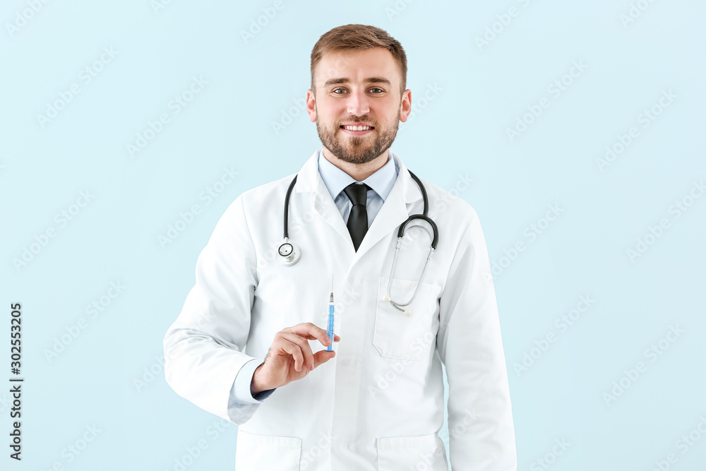 Doctor with syringe on light background Doctor with syringe on light background