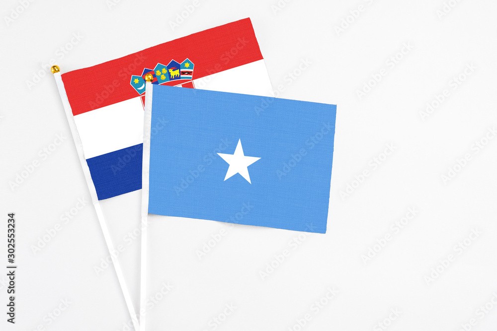 Somalia and Croatia stick flags on white background. High quality fabric, miniature national flag. Peaceful global concept.White floor for copy space. Somalia and Croatia stick flags on white background. High quality fabric, miniature national flag. Peaceful global concept.White floor for copy space.