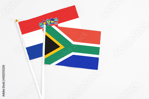 South Africa and Croatia stick flags on white background. High quality fabric  miniature national flag. Peaceful global concept.White floor for copy space.