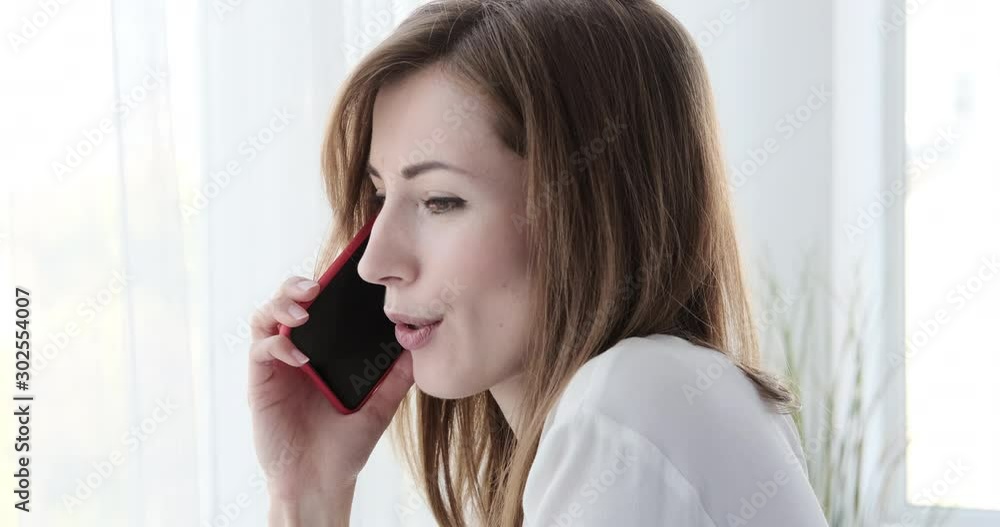 Happy businesswoman talking on mobile phone at office Happy businesswoman talking on mobile phone at office