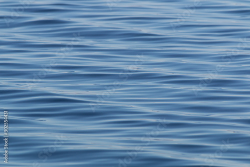 Pattern of a blue ocean with calm tide ripples on the surface
