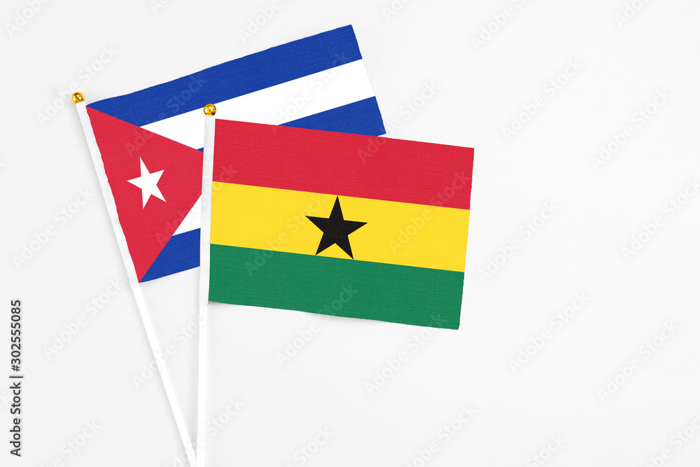 Ghana and Cuba stick flags on white background. High quality fabric, miniature national flag. Peaceful global concept.White floor for copy space. Ghana and Cuba stick flags on white background. High quality fabric, miniature national flag. Peaceful global concept.White floor for copy space.
