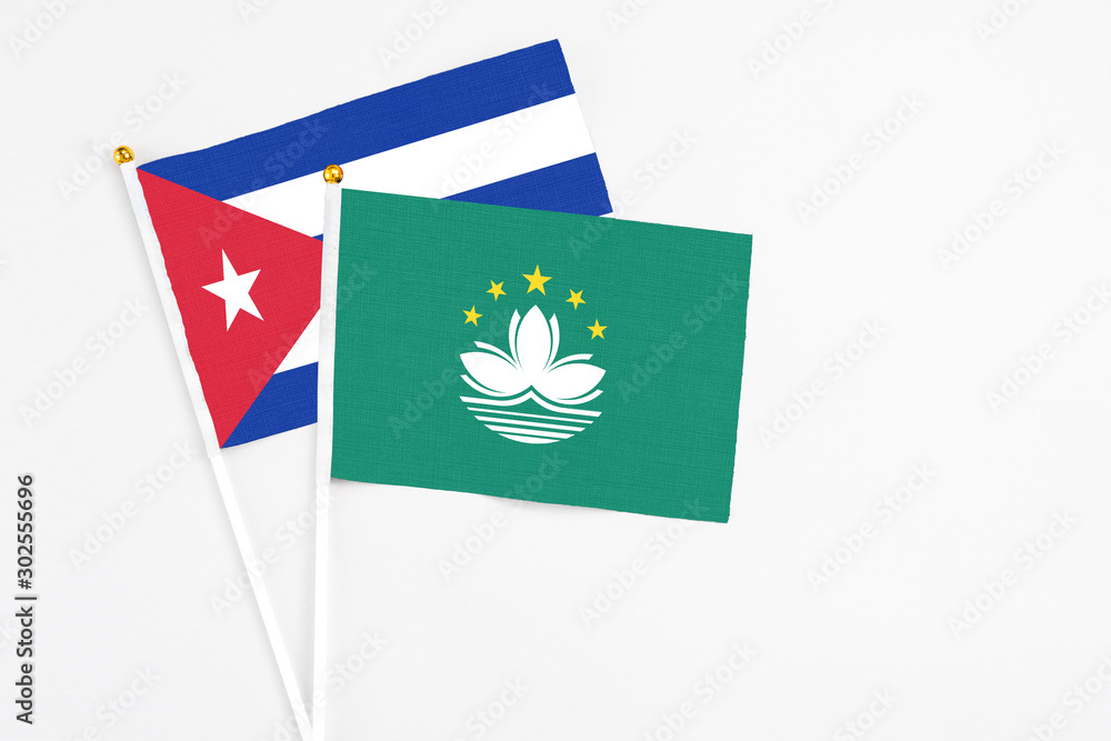 Macao and Cuba stick flags on white background. High quality fabric, miniature national flag. Peaceful global concept.White floor for copy space. Macao and Cuba stick flags on white background. High quality fabric, miniature national flag. Peaceful global concept.White floor for copy space.