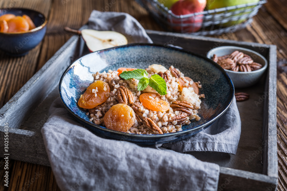 Vegan buckwheat salad with dried apricot, pear and pecan nuts