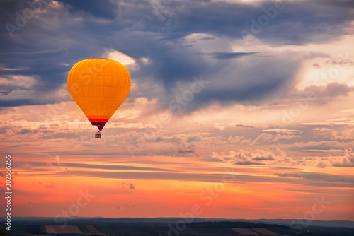 Fotografie Hot Air Baloon Flying with Beautiful Colorful Dramatic Sky at Sunset